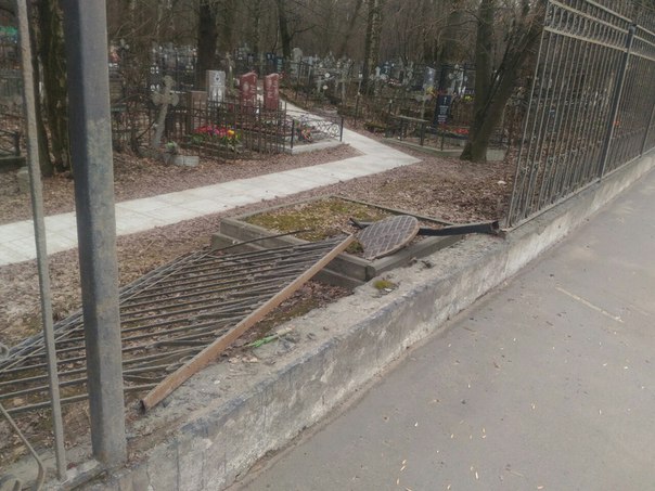Вылетевший из под колёса автомобиля люк поломал забор на Большеохтинском кладбище , кто едет по про...