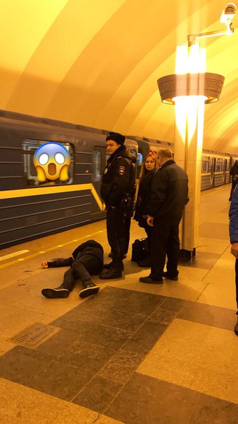На платформе станции Метро Ладожская, лежит молодой человек возле него лужа крови. Рядом стоят сотру...