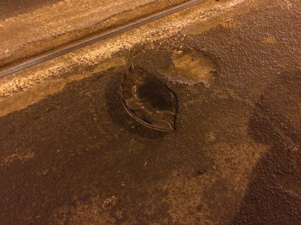 На улице Смолячкова 16, возле метро Выборгская, лежит на дороге обломанная крышка люка , сам люк за...